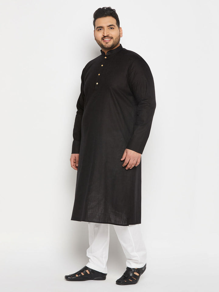 VASTRAMAY Men's Plus Size Black Cotton Kurta And Cotton Pant Style Pyjama Set on a male model standing in front of a traditional background