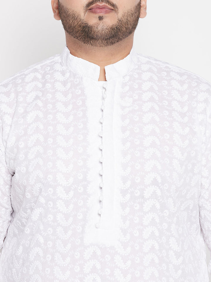 A close-up image of VASTRAMAY Men's Plus Size White Chikankari Embroidered Kurta And White Pyjama Set, showcasing intricate traditional Indian embroidery and comfortable fit