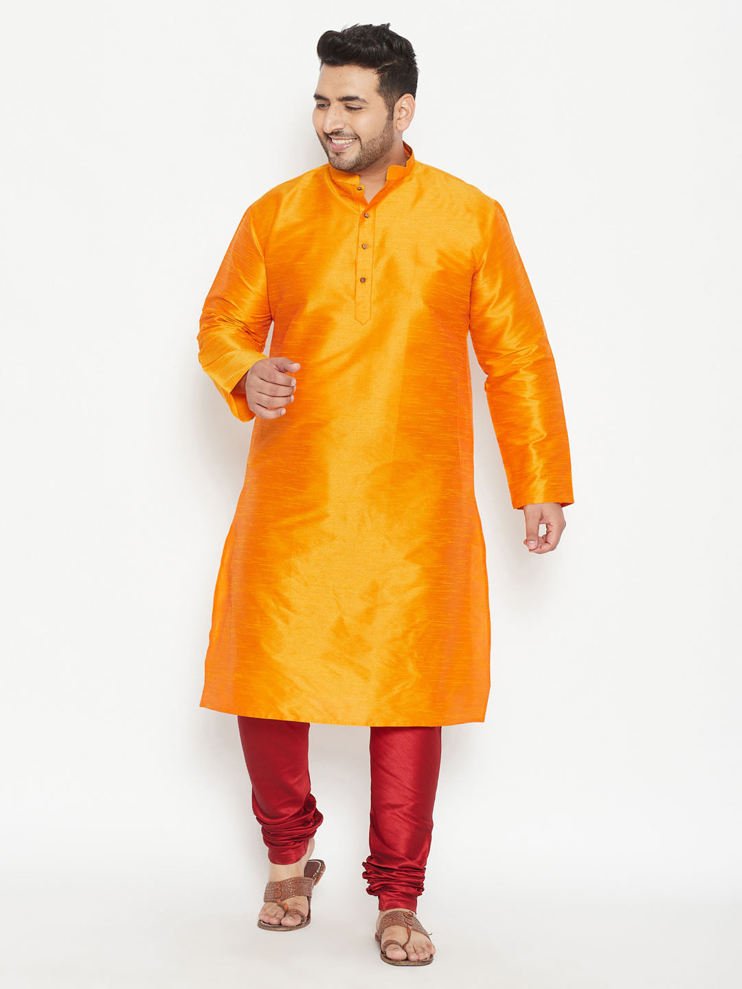 Vibrant orange silk kurta set for men with intricate embroidery details