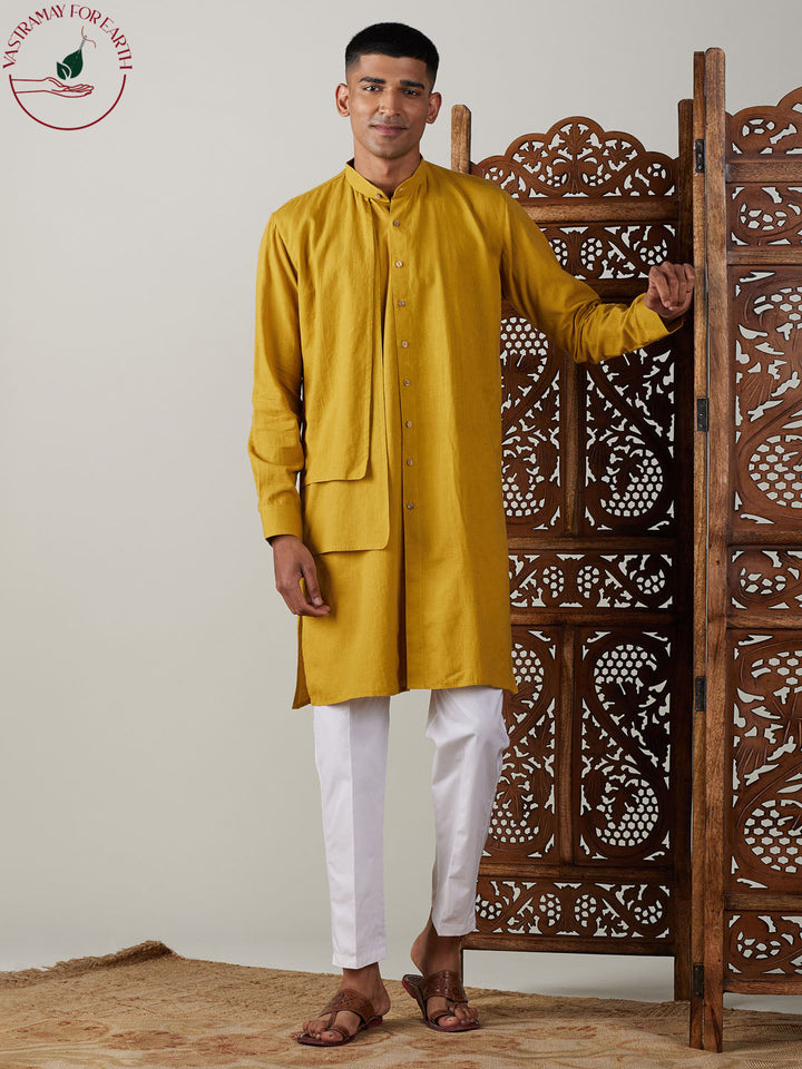 Ethnic Indian outfit for men in mustard color with intricate embroidery and comfortable white pants