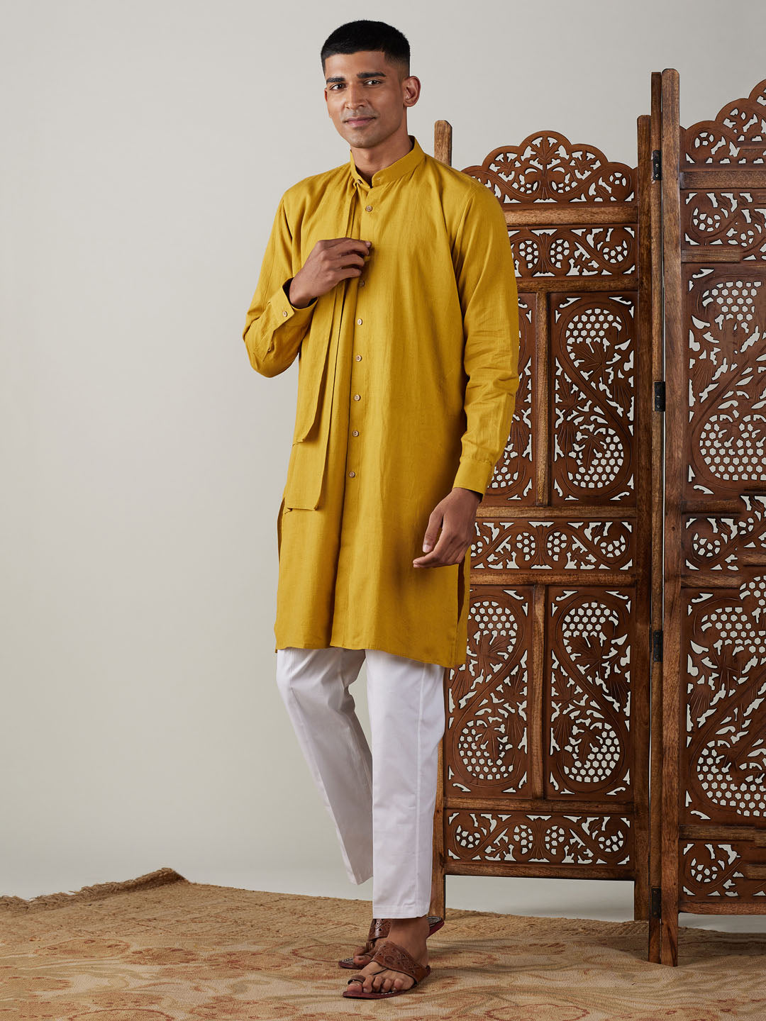 Two-piece men's traditional Indian outfit in mustard color with intricate embroidery