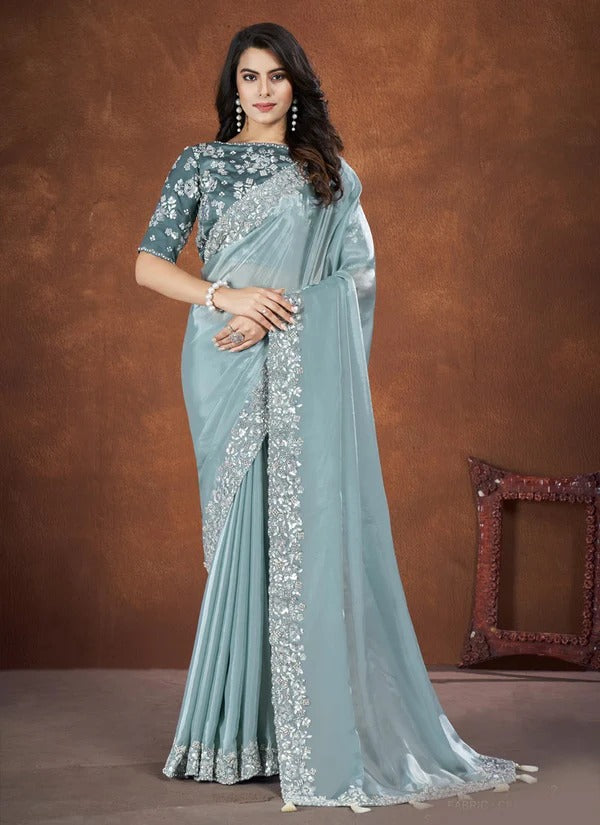 Turquoise crepe satin silk saree with intricate embroidery and matching stitched blouse