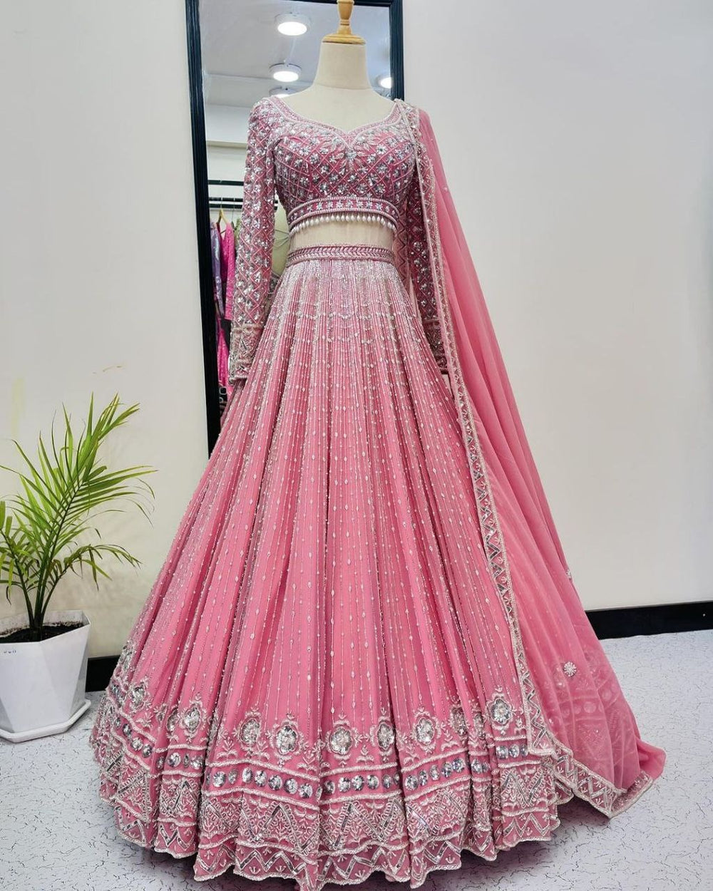 Beautiful pink bridal wear lehenga choli with heavy embroidery and sequin work, paired with a matching dupatta