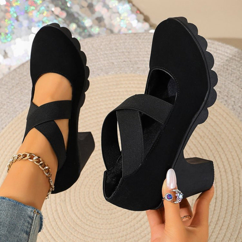 Women's black Mary Jane shoes by Bootara with round toe, cross-strap, chunky lug sole, and block heels in smooth material.