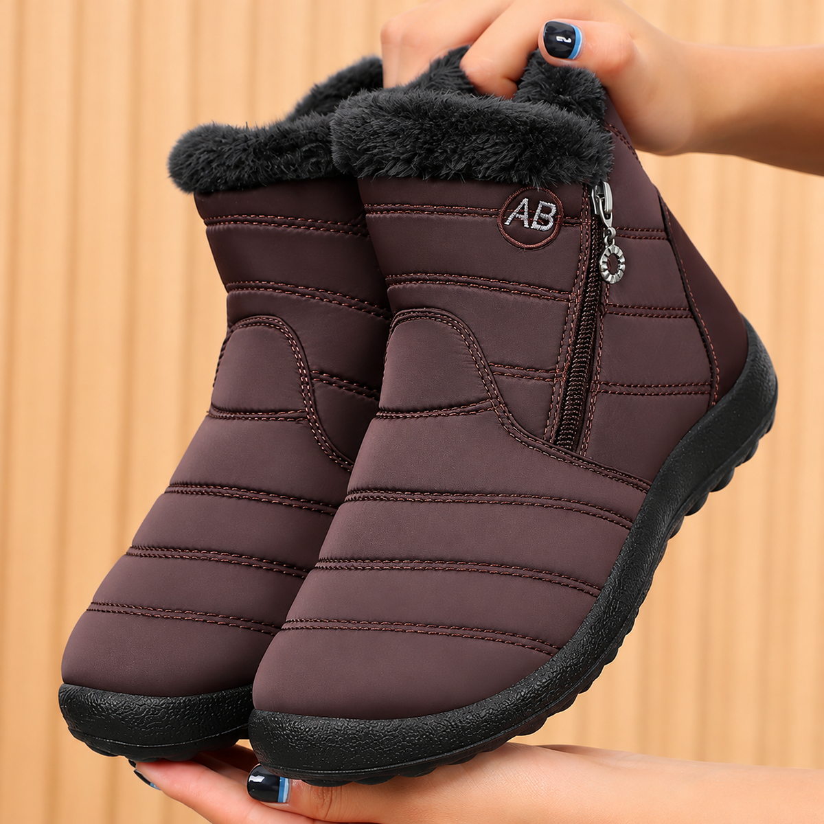 Women's Bootara Norwyn snow boots in brown with water-resistant exterior, fleece lining, and side zipper, high-top winter footwear.