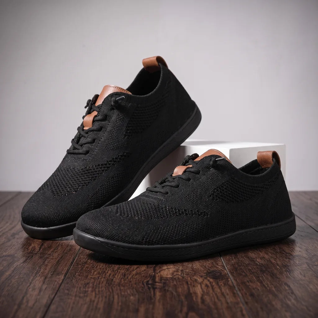 Black men's barefoot sneakers from Ethan by Qivii, designed for comfort and minimalistic style, featuring a sleek sneaker silhouette.