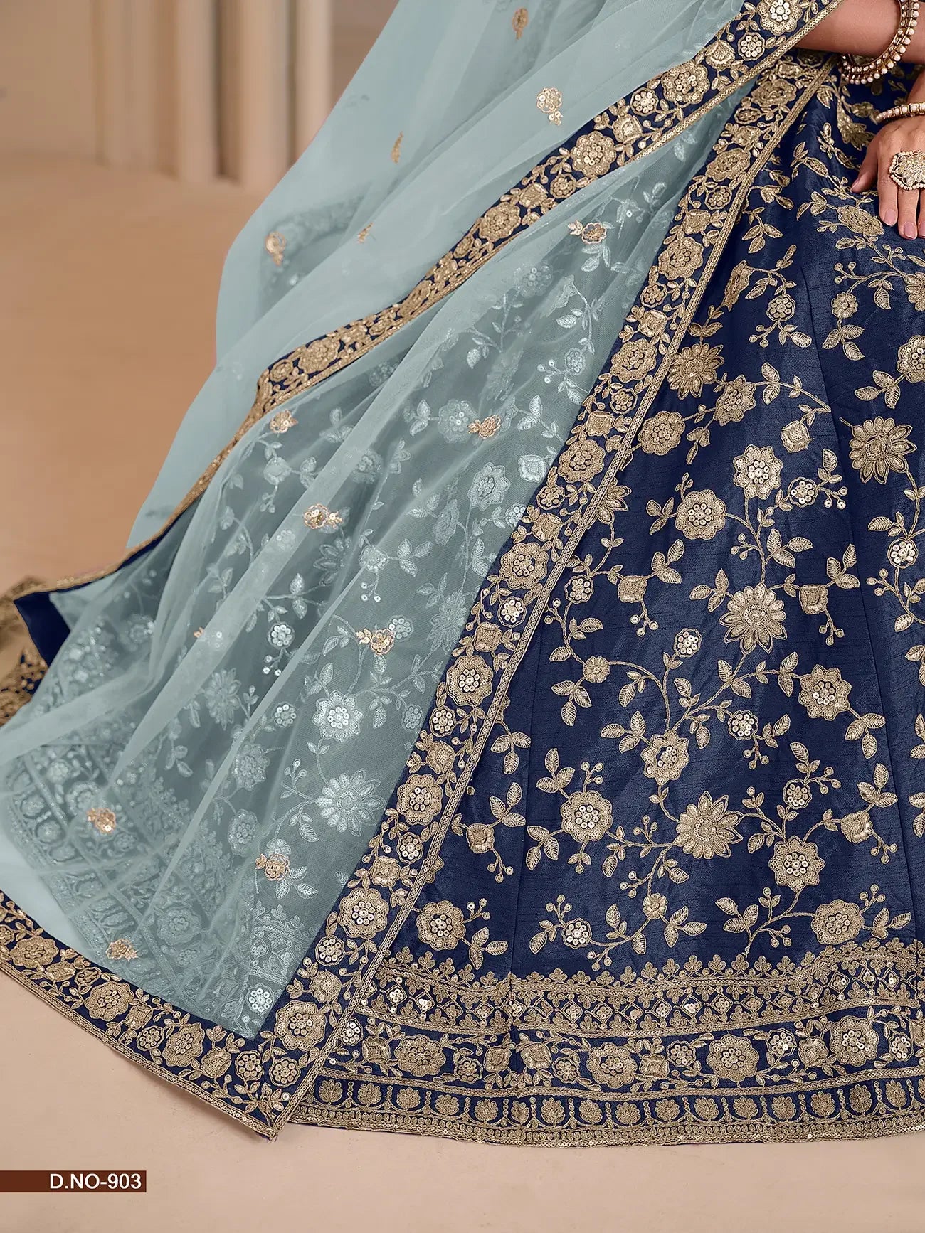 Blue and gold embroidered lehenga with sheer light blue dupatta, floral patterns, ornate border
