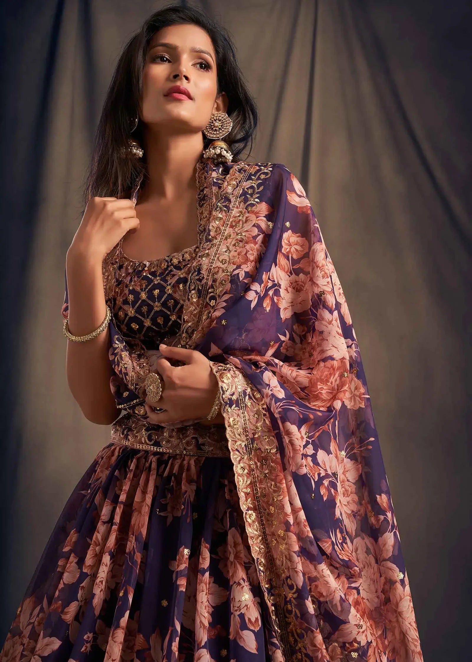 Woman in navy blue floral ethnic dress with gold embroidery and sheer dupatta