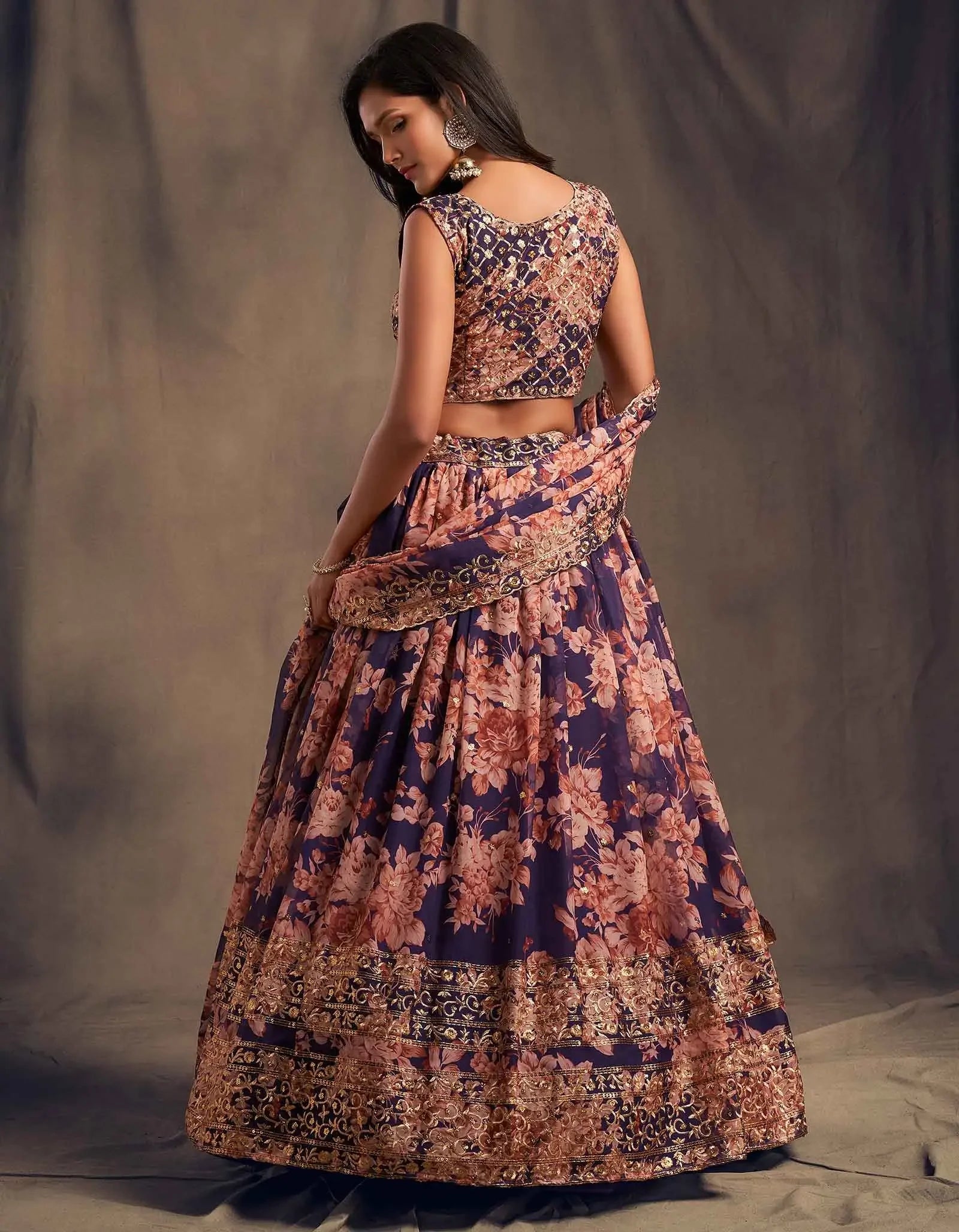 Woman in a purple floral lehenga with gold embroidery, traditional ethnic outfit