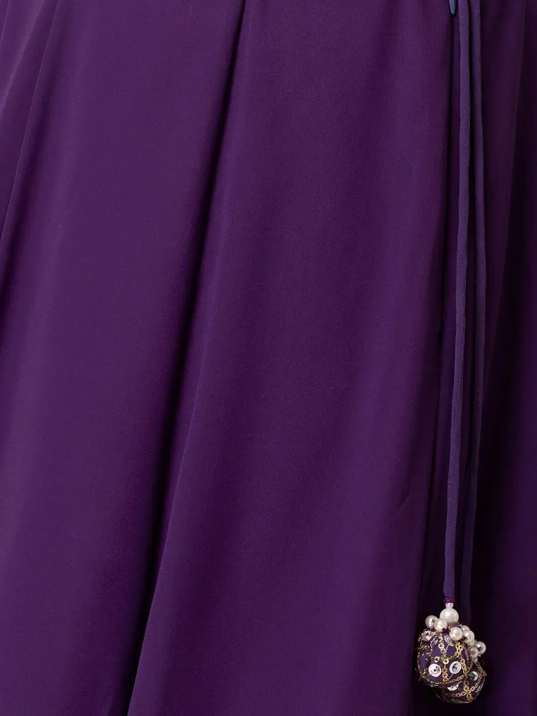 Purple fabric with decorative tassel and pearl embellishments