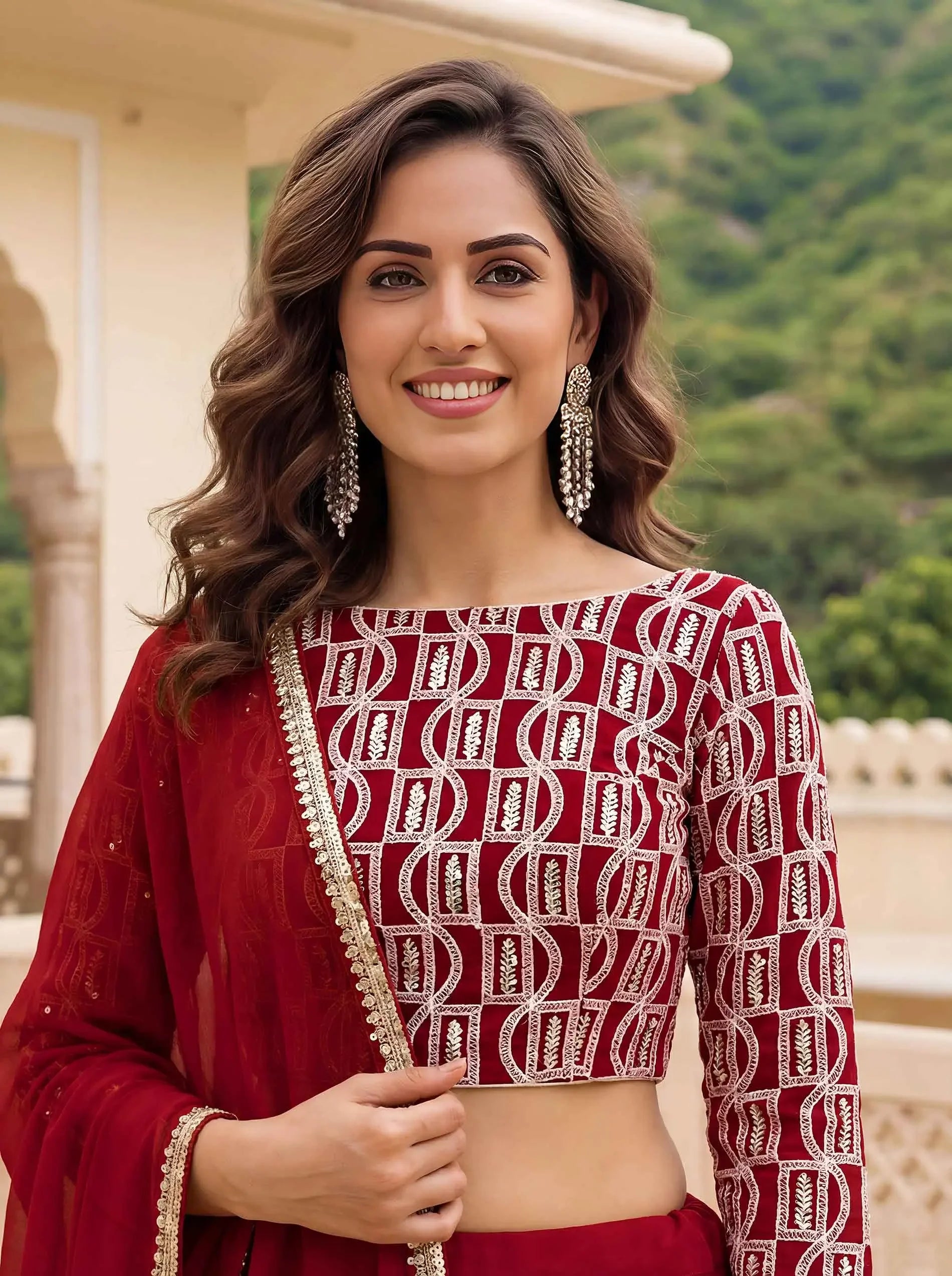 Woman wearing red embroidered blouse and dupatta, outdoor traditional outfit shoot