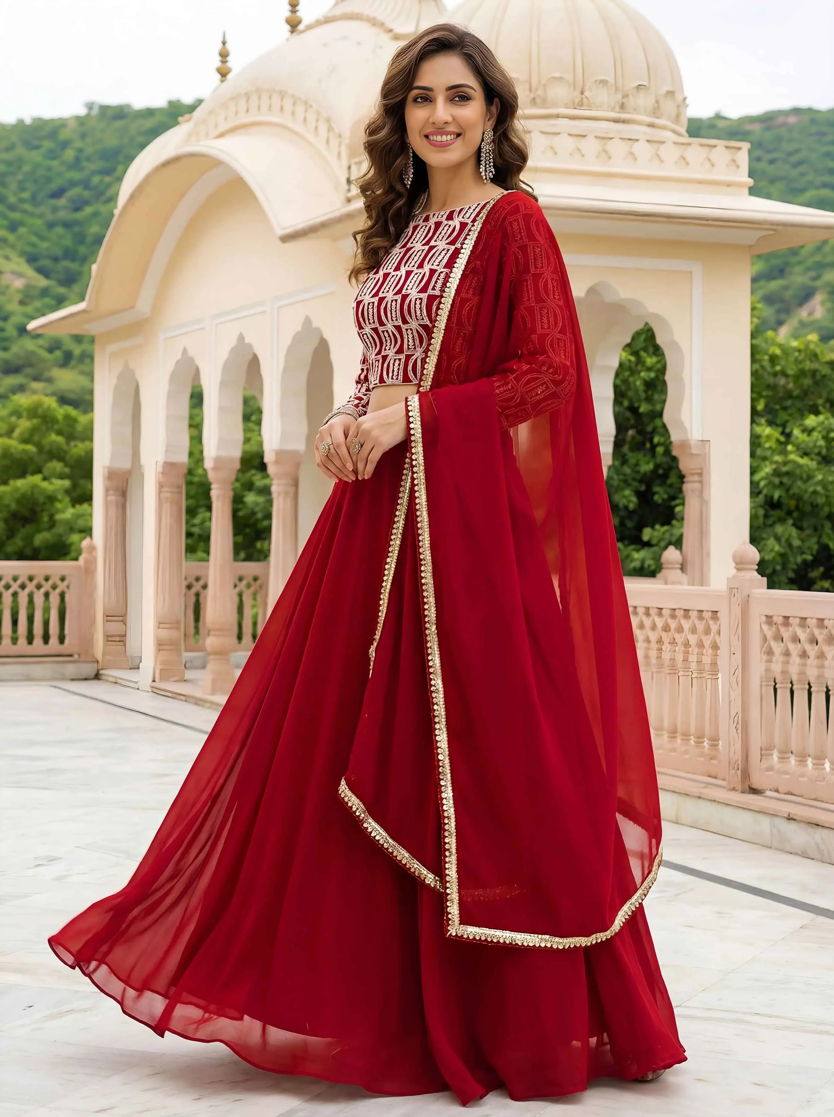 Woman in elegant red ethnic dress with gold border, traditional architecture background