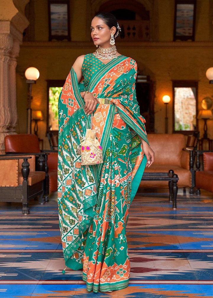 Green & Orange Printed Patola Silk Saree with Zari Border & Tassels on Pallu | Stitched Blouse - qivii