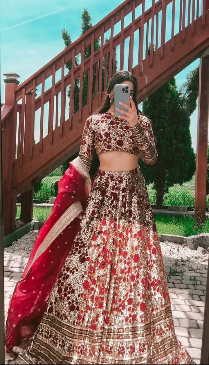 Red lehenga with intricate gold embroidery work and matching choli