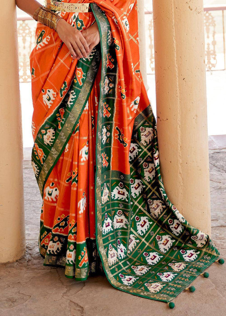 Pumpkin Orange Printed Patola Silk Saree with Zari Border & Tassels on Pallu | Stitched Blouse - qivii