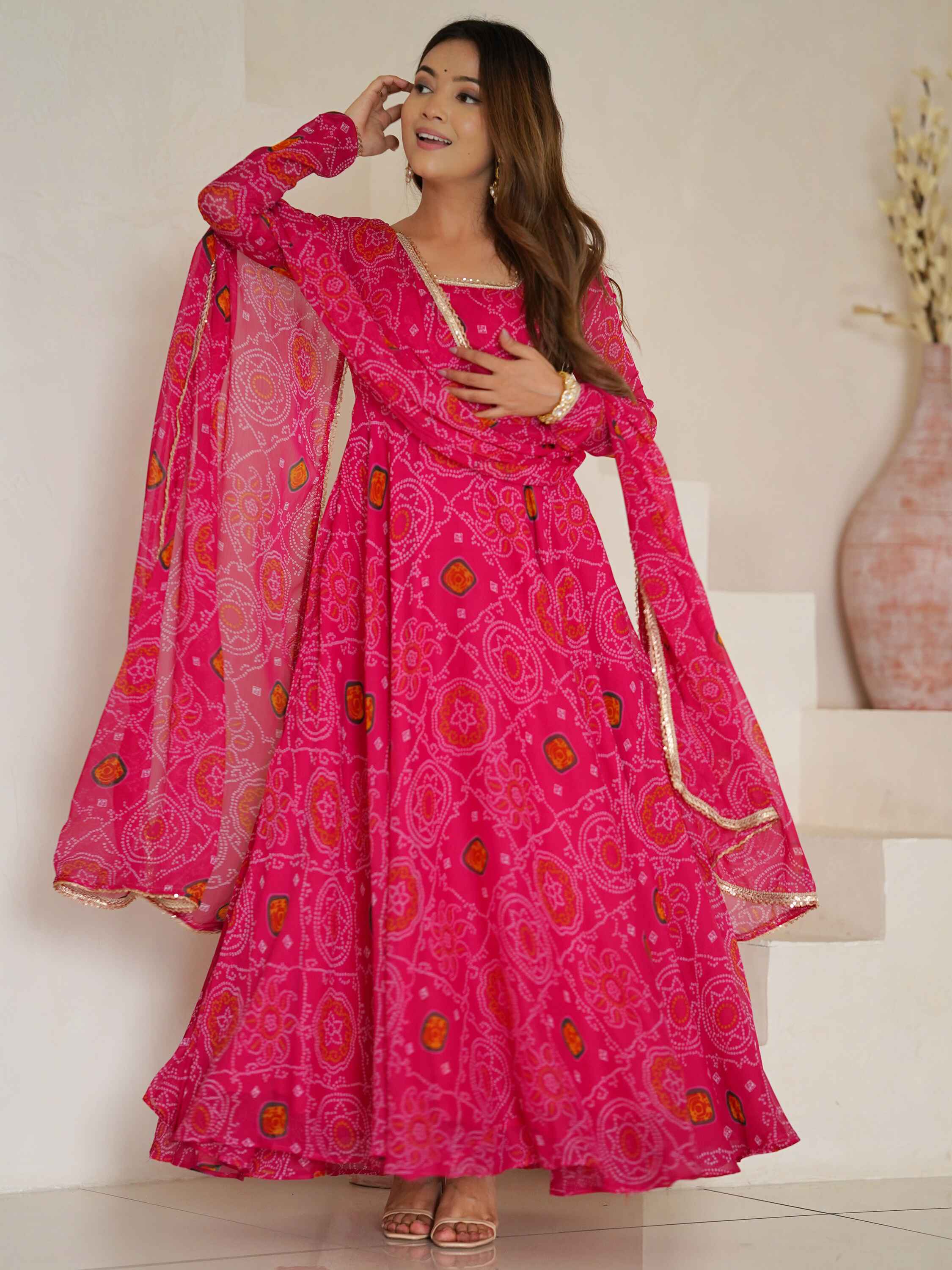 Exquisite pink georgette anarkali suit with bandhej print border and lace detailing